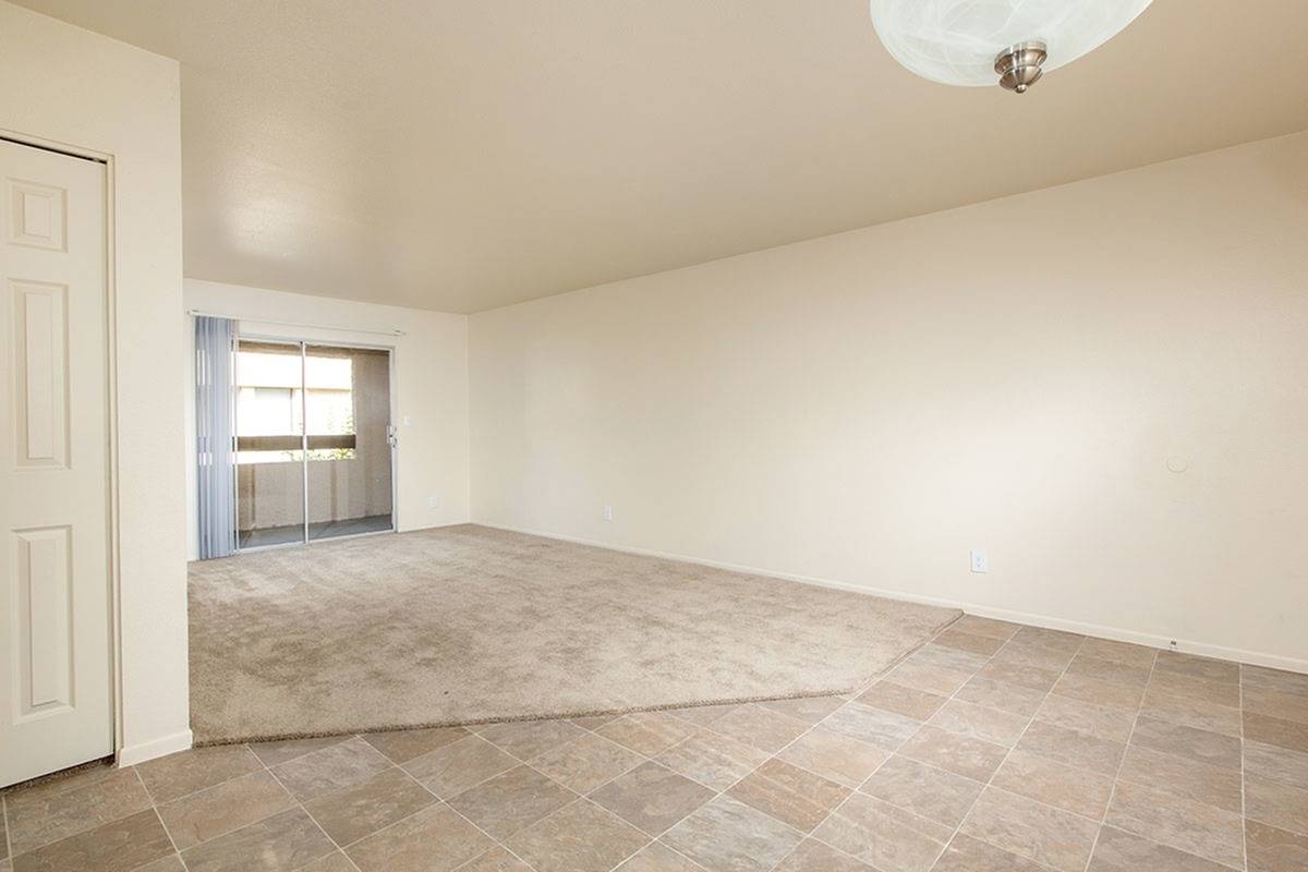 living room with beige carpet and sliding doors to balcony at Bridge Lane
