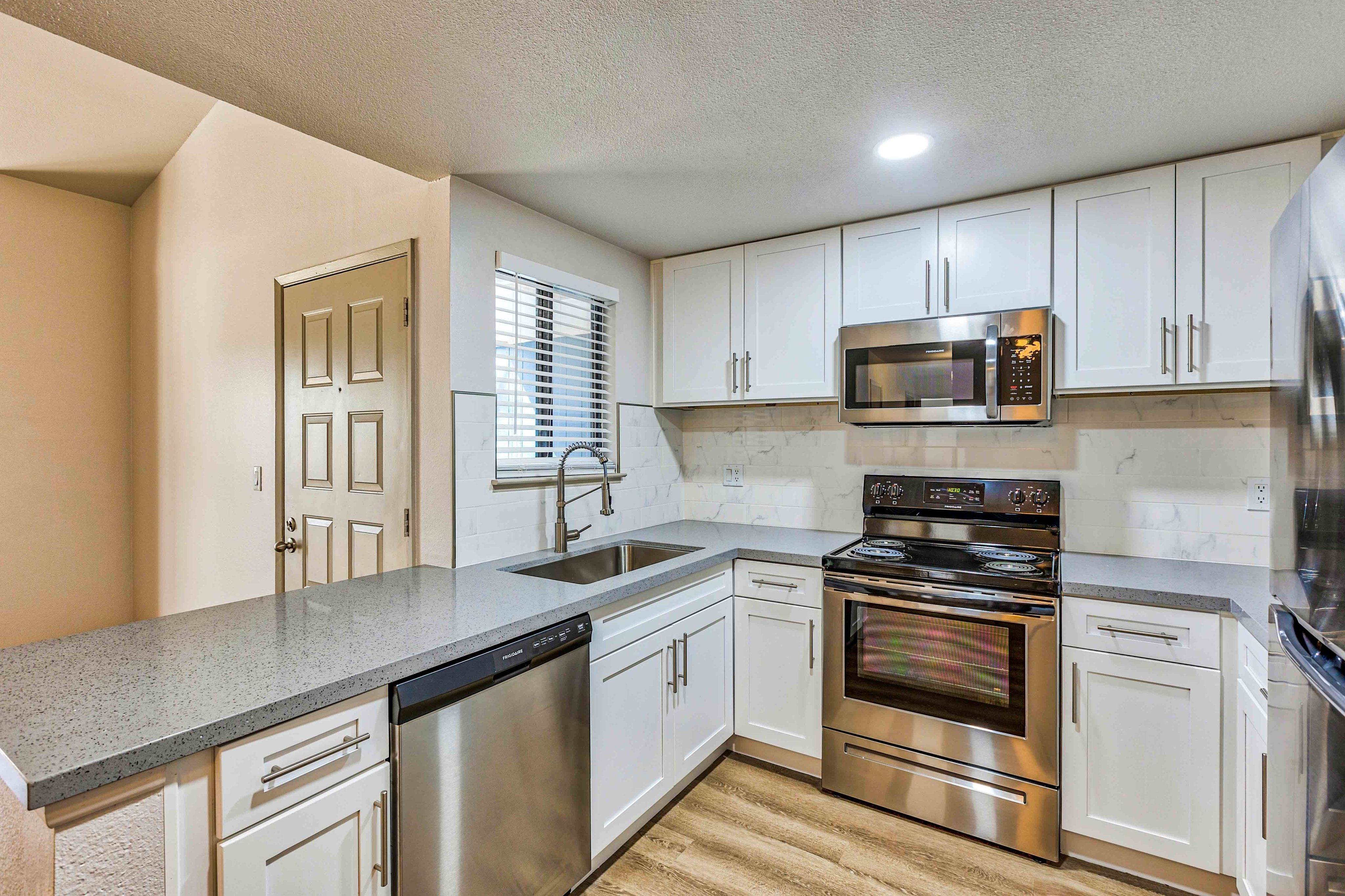 kitchen with granite countertops and stainless steel appliances and at redfield ridge apartments