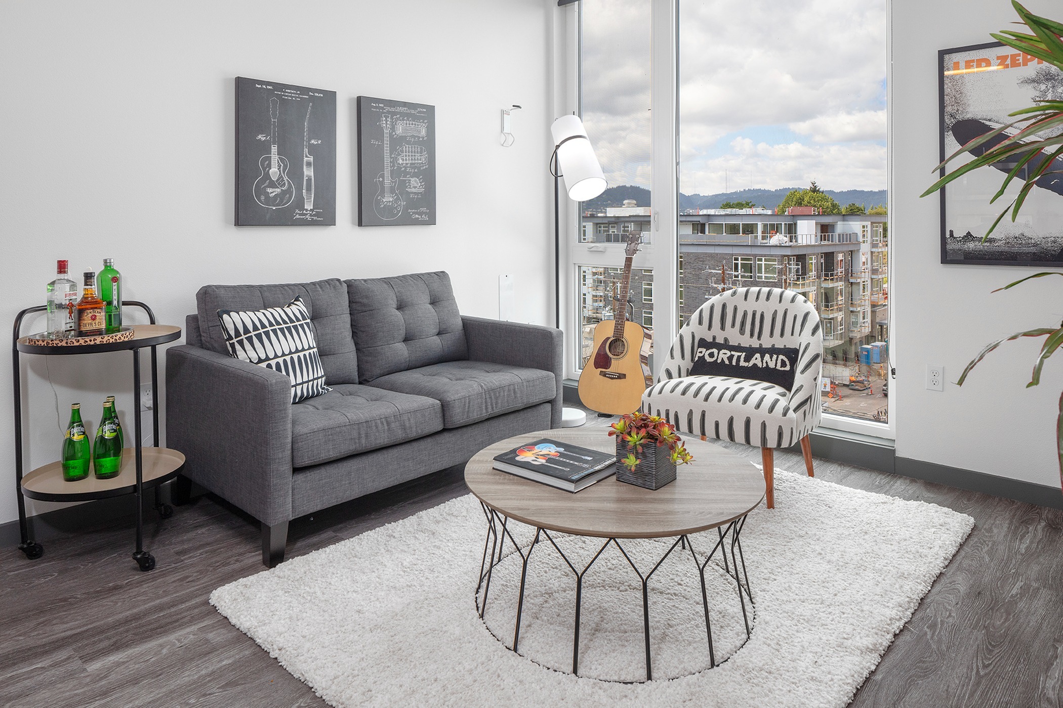 living room with grey sofa and round coffee table with vinyl wood like flooring at parallax apts