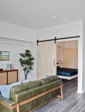 living room with leather sofa and vinyl wood like flooring at oro apartments