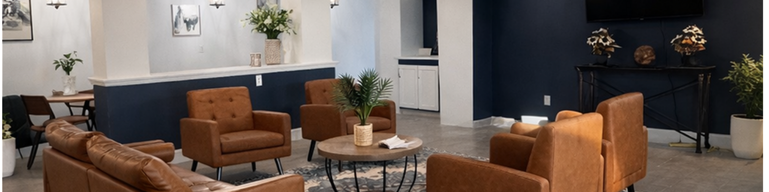 Elegant and spacious living area with modern brown leather seating, stylish decor, and a cozy ambiance perfect for relaxation.