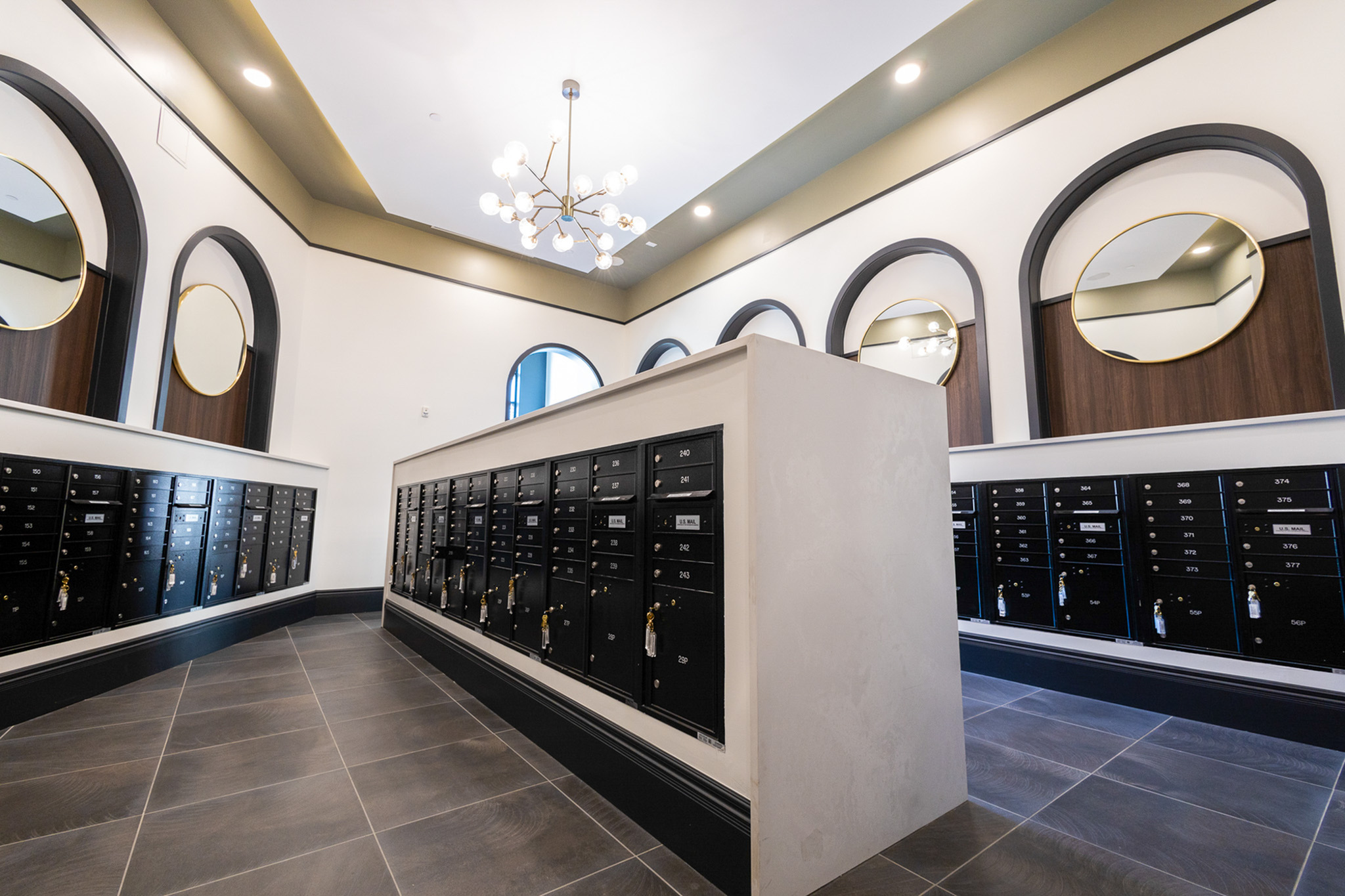 Resident mail area with arched architectural details at Woodburn Exchange apartments