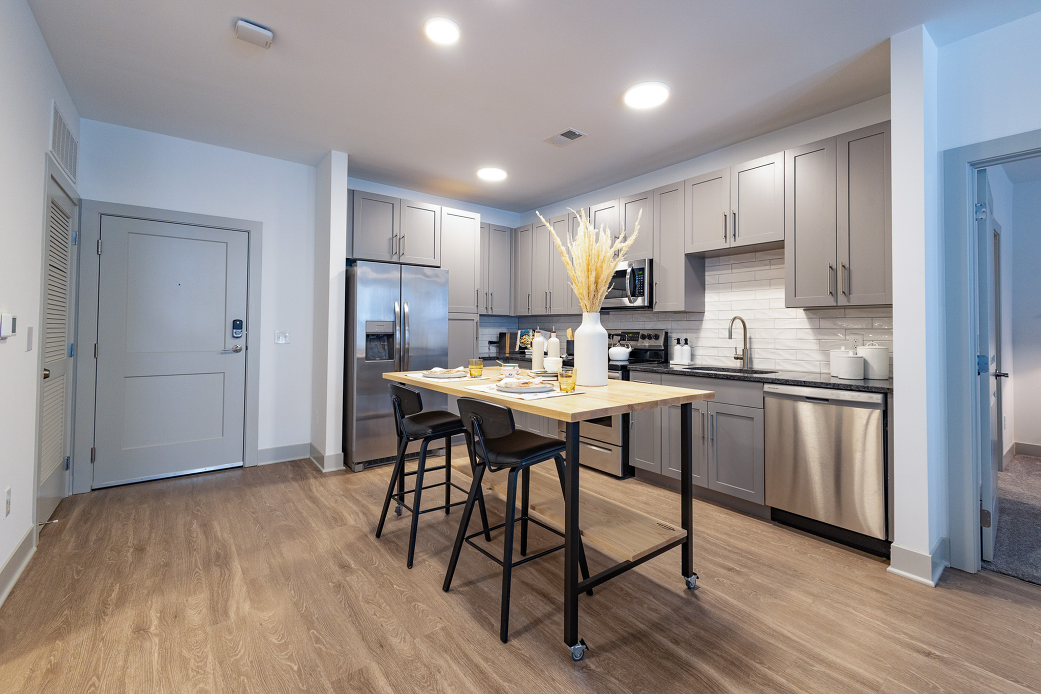 Contemporary apartment kitchen with stainless-steel appliances at Woodburn Exchange in East Walnut Hills