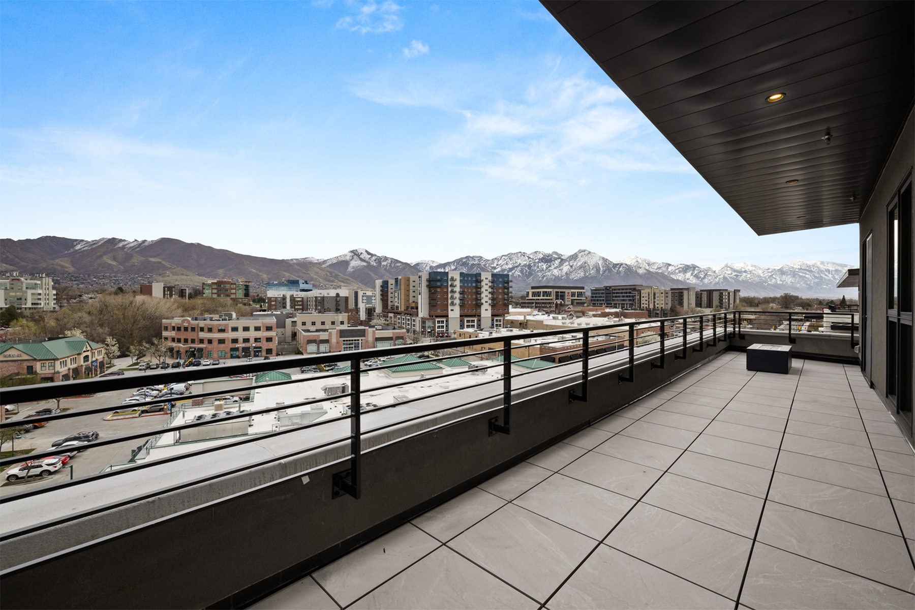 xpansive penthouse balcony at Sugar Alley overlooking Sugar House and the Wasatch mountain range.