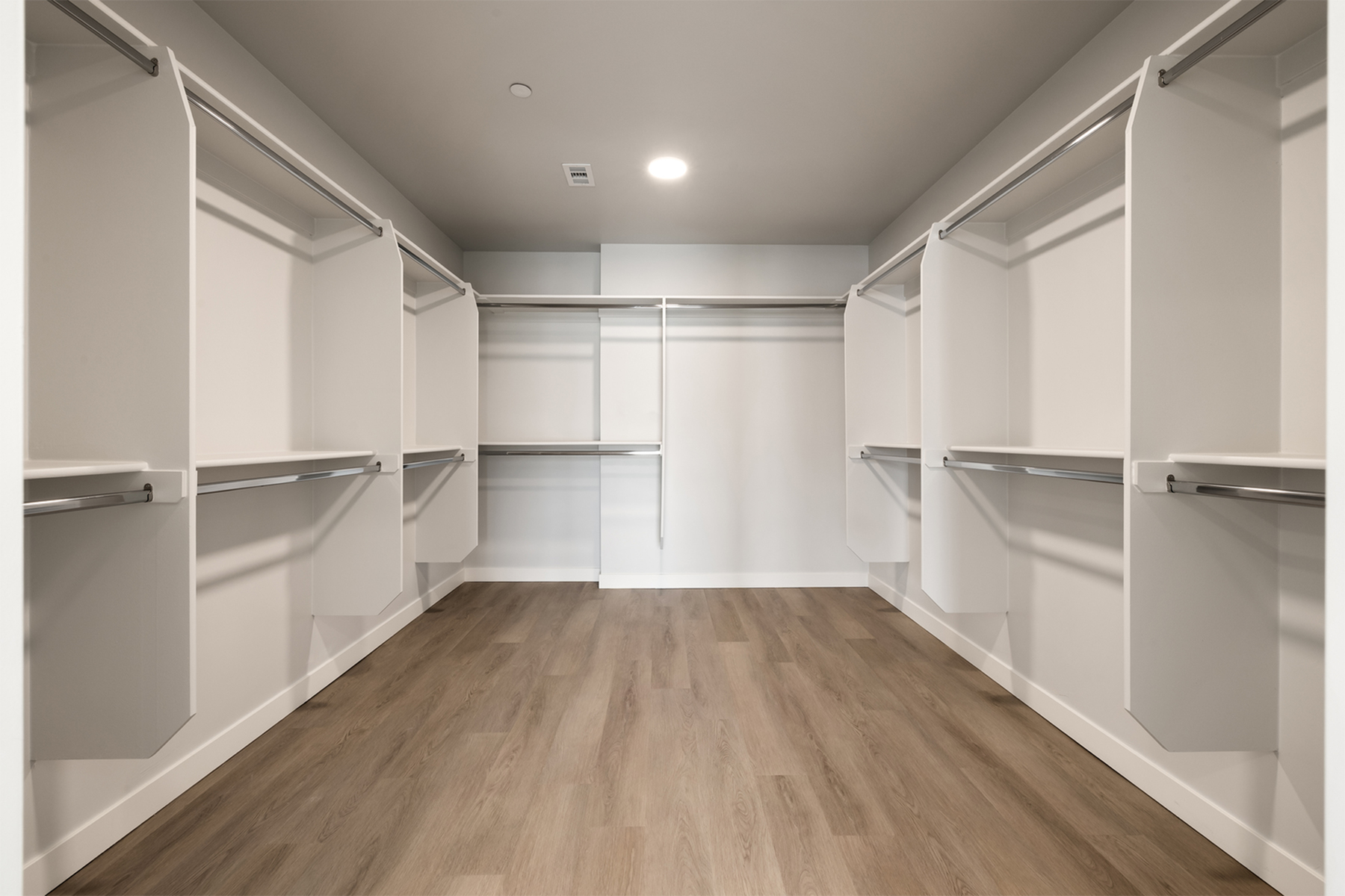 Expansive penthouse walk-in closet at Sugar Alley featuring full-height shelving and abundant storage space.