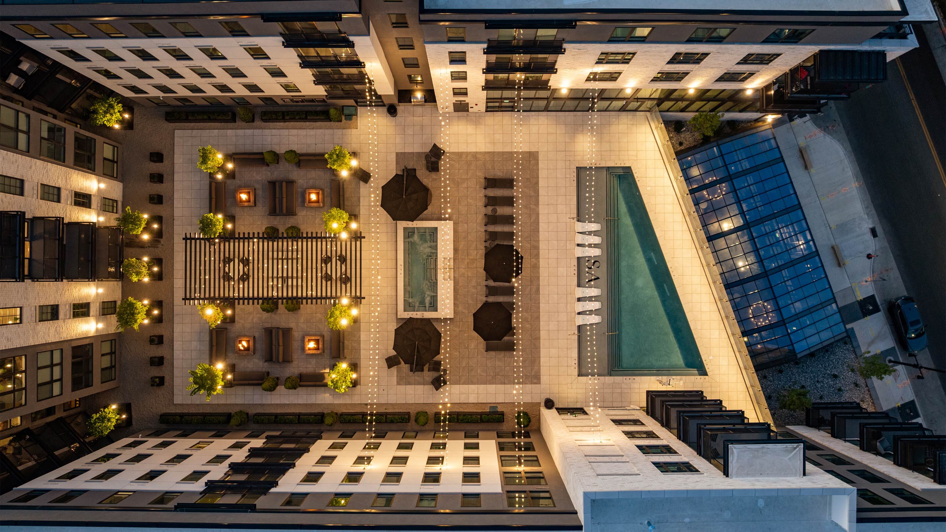Rooftop pool deck at Sugar Alley with resort-style seating and Sugar House views.