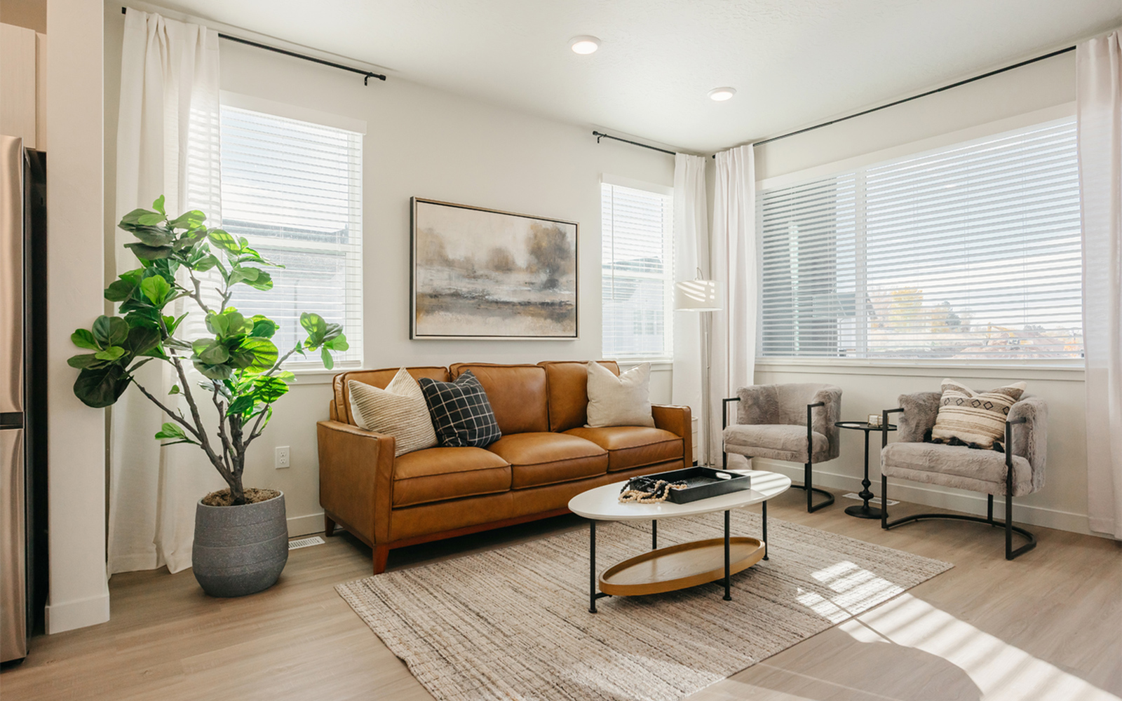 Open-concept living room inside a Railrunner townhome in Roy, Utah.