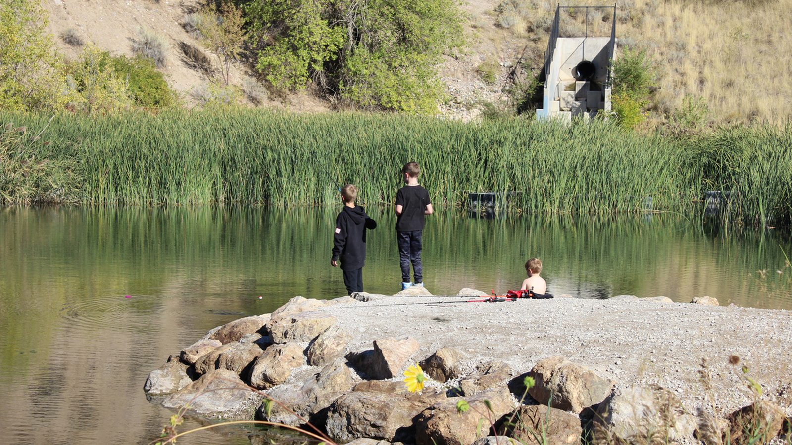 Residents enjoying fishing at the on-site pond at Eaglewood Lofts in North Salt Lake.