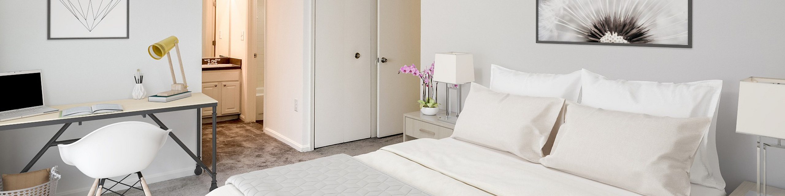 Bright and tranquil bedroom with elegant decor, featuring a cozy bed, a sleek workspace, and a modern ensuite bathroom.
