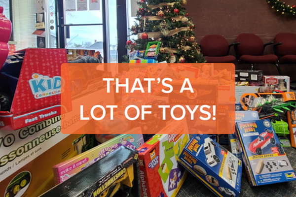 christmas tree with a large pile of new toys under it and text that says that's a lot of toys