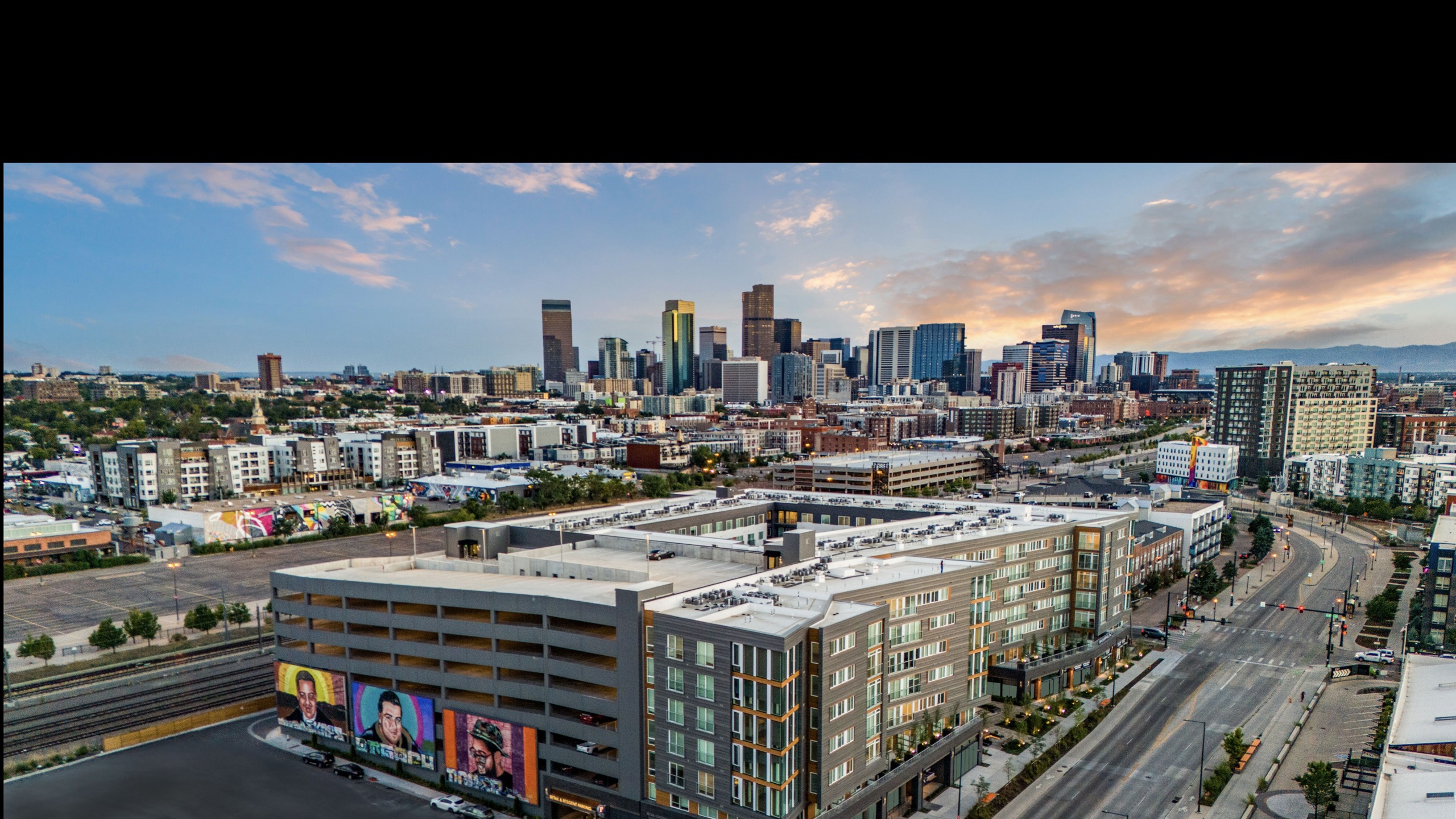 exterior birdseye view of Hanover RiNo with downtown Denver in background