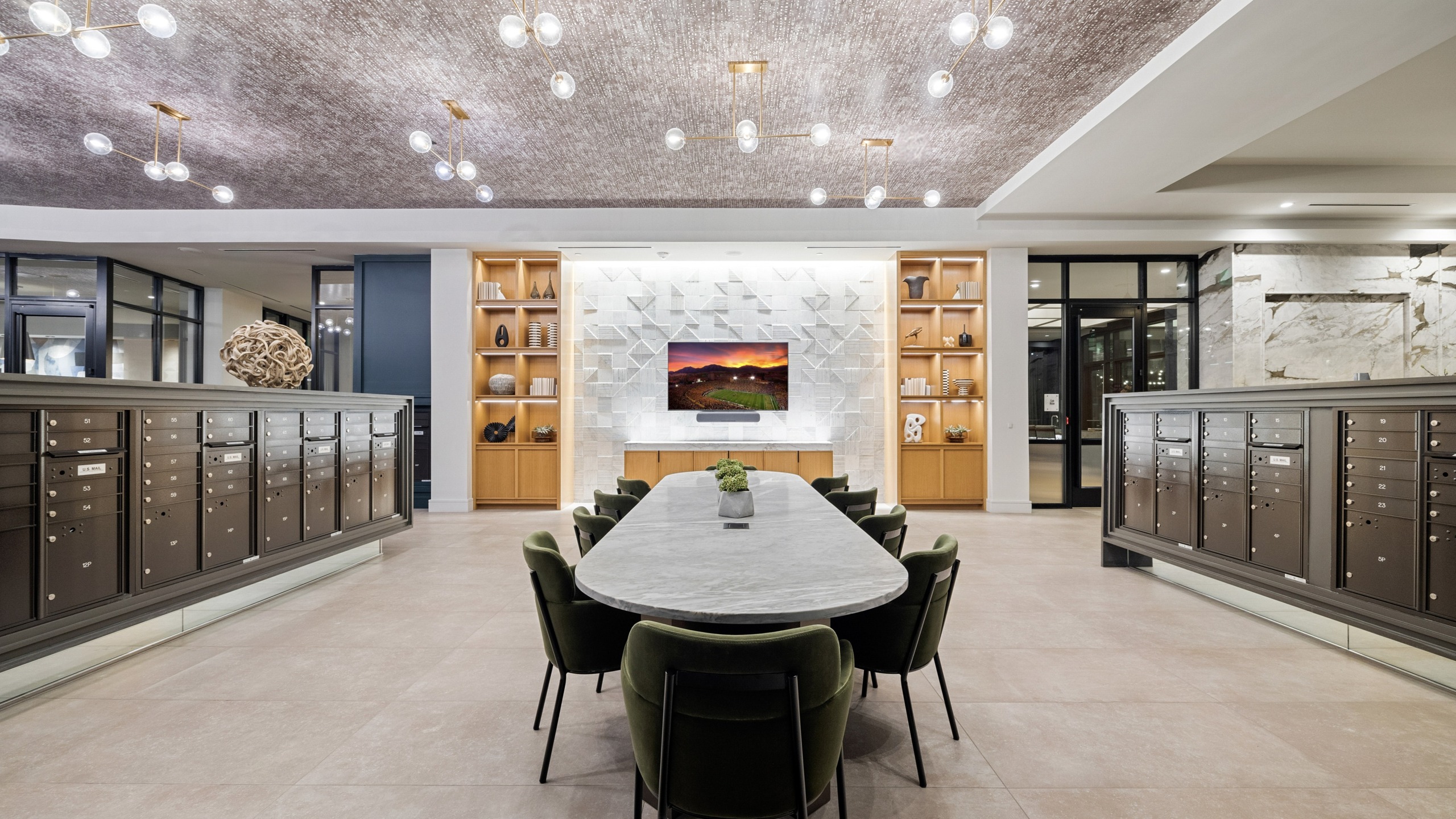 coworking space with 10-seater table, built-in shelves, tv, and mailboxes on either side