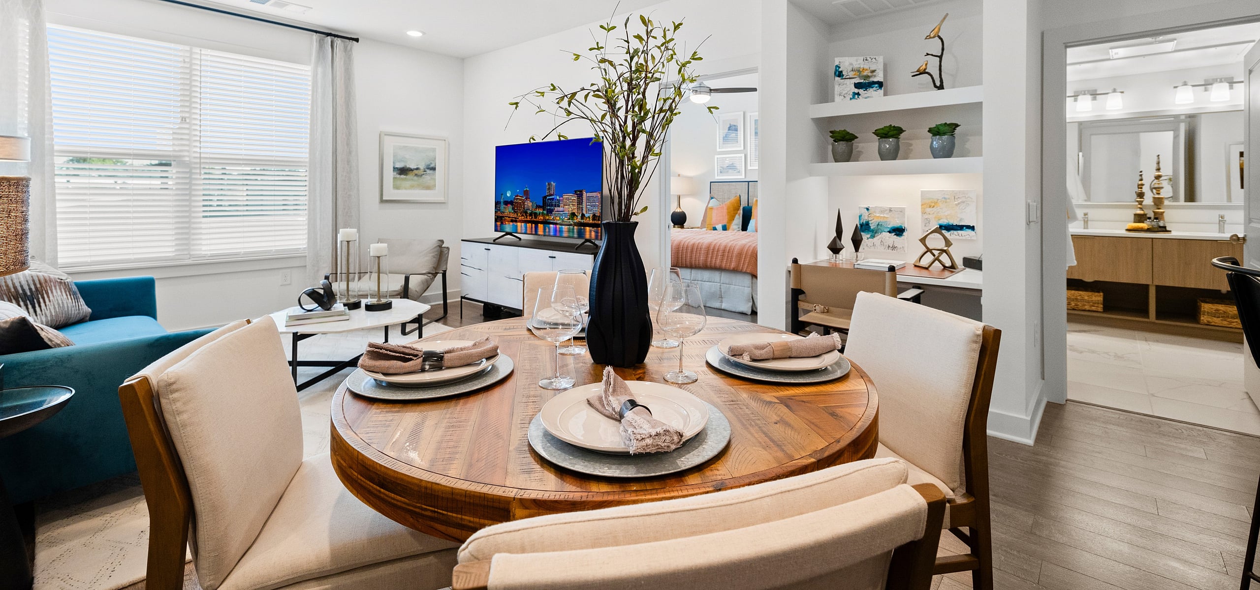 Inviting open-plan living space with chic dining area, vibrant decor, and cozy ambiance.