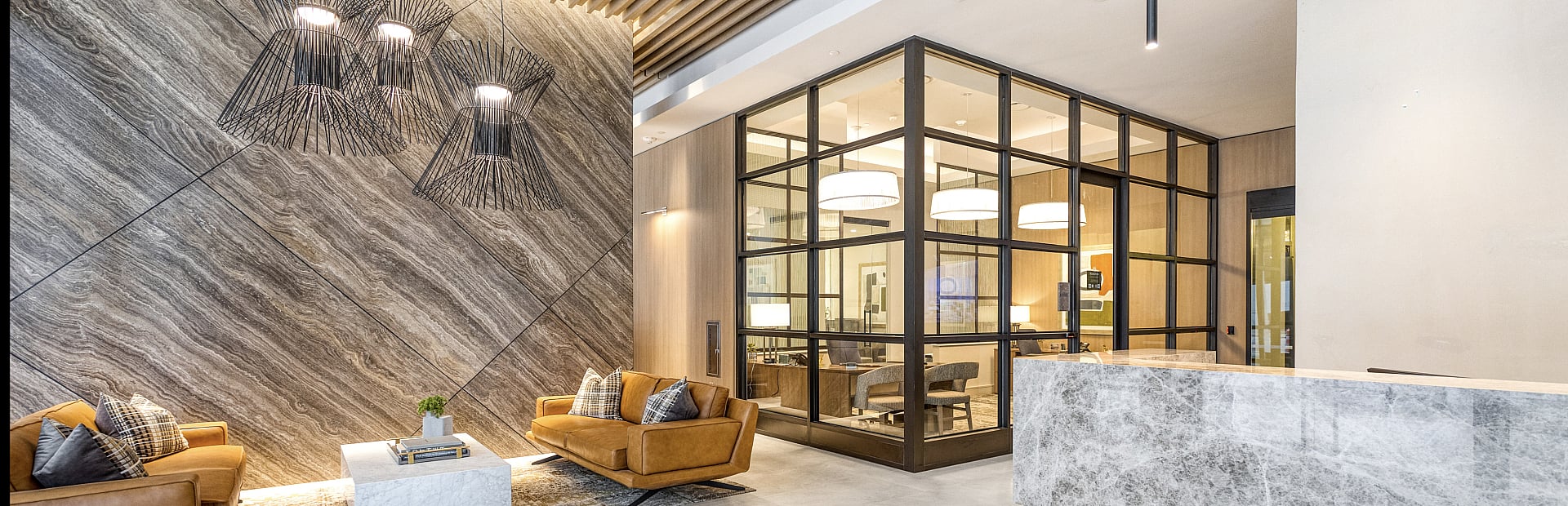 Luxurious modern lobby featuring elegant marble reception, cozy leather seating, and chic decorative lighting.