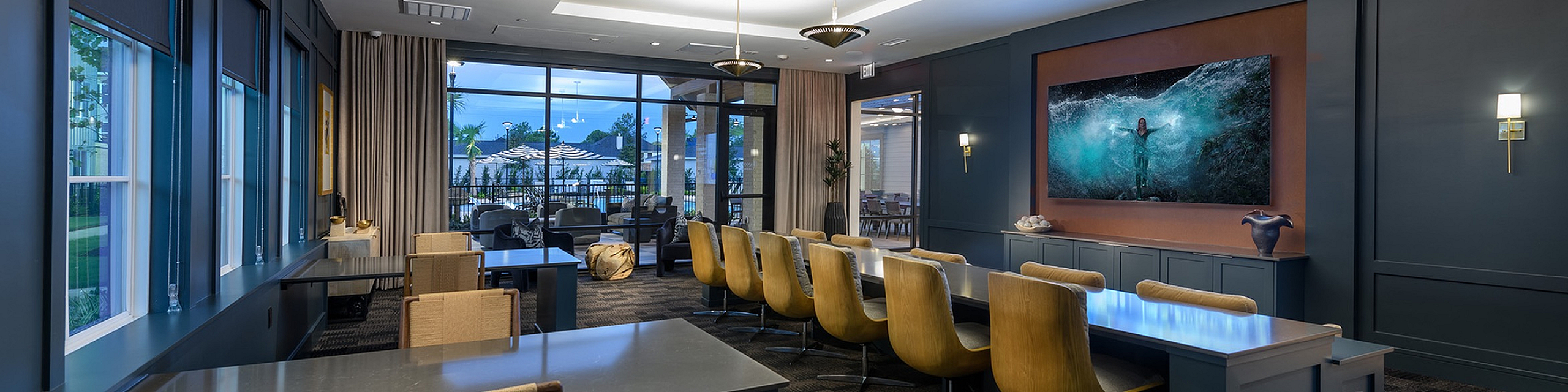 Luxurious meeting room with elegant lighting, oversized windows, and contemporary decor, offering a serene ambiance and garden views.