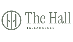 Elegant logo of The Hall Tallahassee featuring a minimalist design with thin, sophisticated typography and a circular emblem.