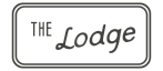 Elegant sign reading 'The Lodge' in a modern, stylish font.